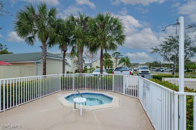 view of swimming pool with an in ground hot tub