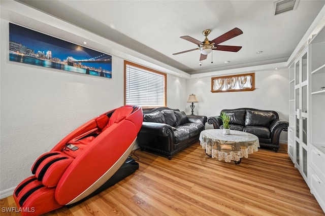 living room with a wealth of natural light, hardwood / wood-style floors, and ceiling fan