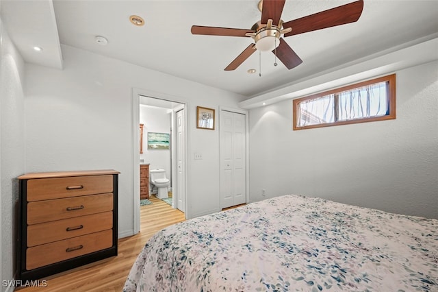 bedroom featuring ensuite bathroom, ceiling fan, and light wood-type flooring