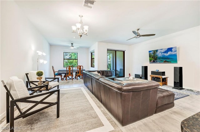 living room with ceiling fan with notable chandelier