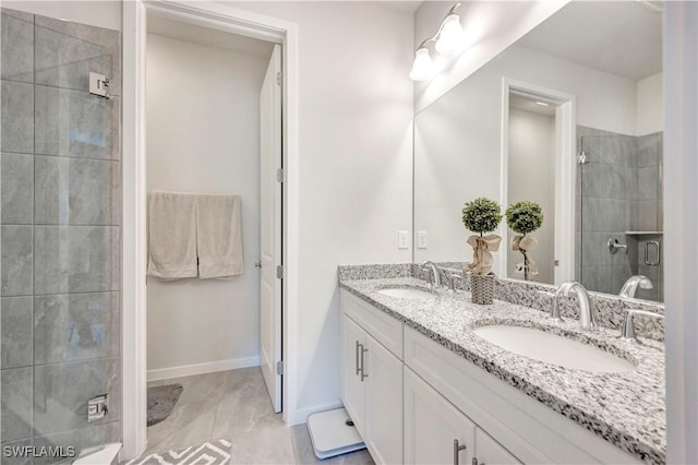 bathroom with a shower with door and vanity