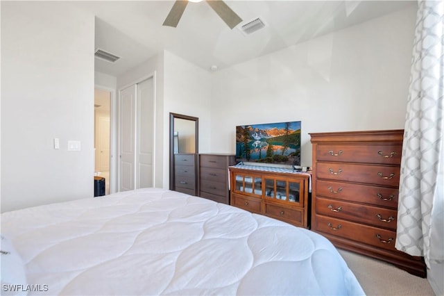 carpeted bedroom featuring ceiling fan and a closet