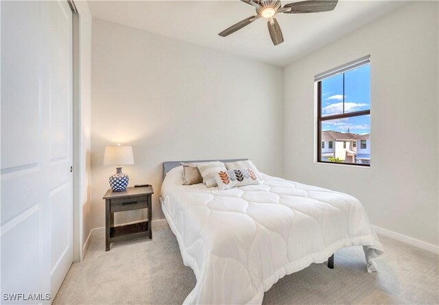 carpeted bedroom featuring ceiling fan