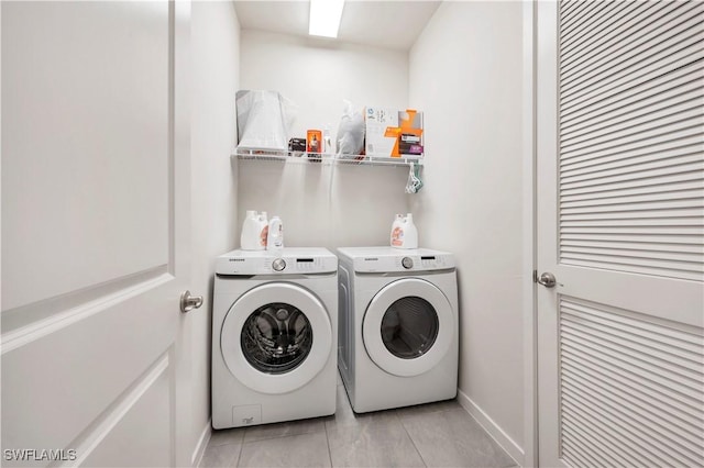 laundry area featuring light tile patterned floors and independent washer and dryer