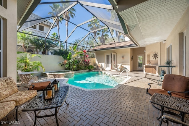 view of swimming pool featuring an outdoor hangout area, a patio area, glass enclosure, and an in ground hot tub