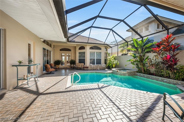 view of pool with an in ground hot tub, a lanai, a patio, and french doors
