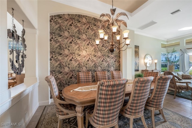 dining room with light tile patterned flooring, crown molding, and a notable chandelier