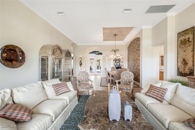 living room with crown molding, a chandelier, and a high ceiling