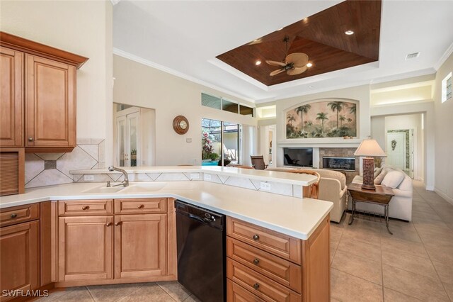 kitchen with sink, crown molding, a tray ceiling, dishwasher, and decorative backsplash