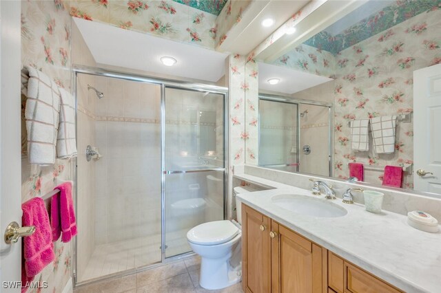 bathroom featuring vanity, an enclosed shower, tile patterned floors, and toilet