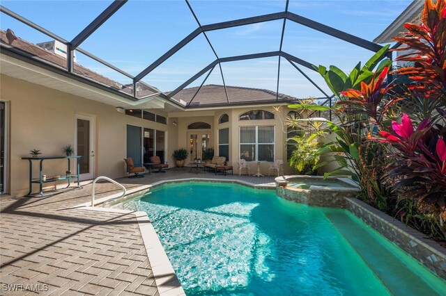 view of swimming pool featuring an in ground hot tub, a lanai, and a patio area