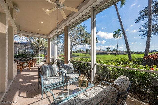 sunroom / solarium featuring ceiling fan