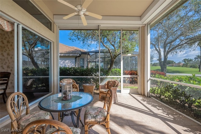 sunroom / solarium with a wealth of natural light and ceiling fan
