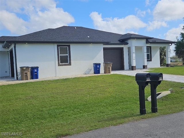 view of front of property featuring a garage and a front yard