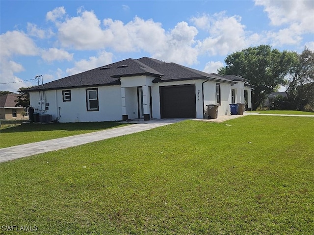 view of front facade featuring a garage, a front yard, and central AC unit