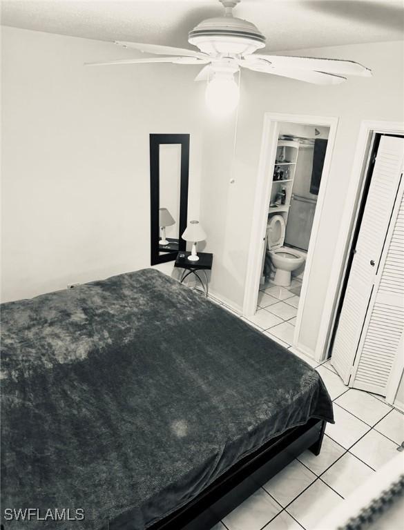 tiled bedroom featuring ceiling fan