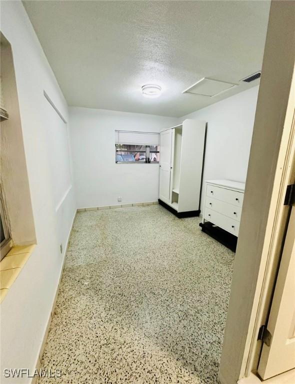 basement featuring a textured ceiling