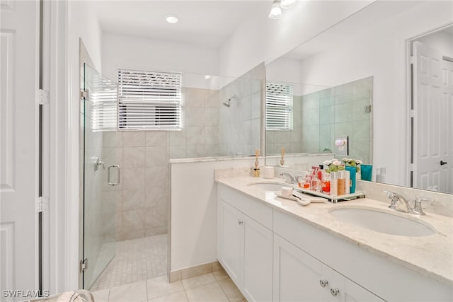 bathroom featuring radiator heating unit, a shower with shower door, tile patterned flooring, and vanity