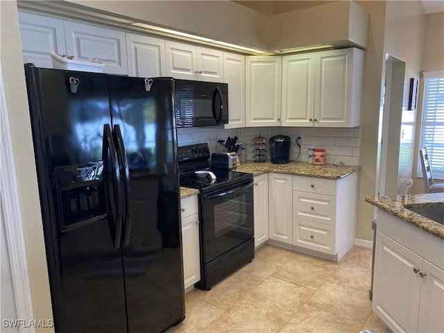 kitchen featuring white cabinetry, light stone countertops, and black appliances