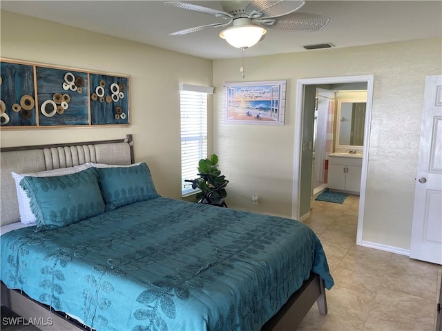 tiled bedroom with ensuite bath and ceiling fan