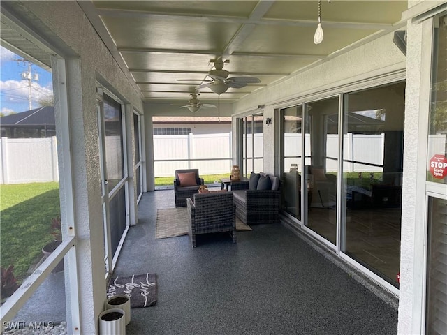 unfurnished sunroom with ceiling fan and plenty of natural light