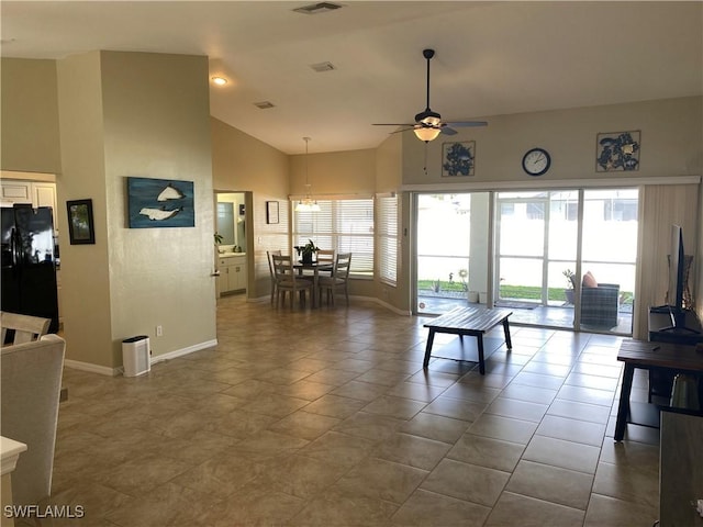 living room featuring tile patterned flooring, ceiling fan, and high vaulted ceiling