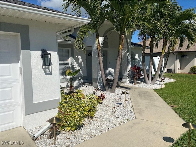 view of property exterior featuring a garage and a yard