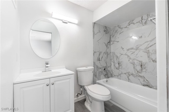 full bathroom with tiled shower / bath, hardwood / wood-style floors, vanity, and toilet