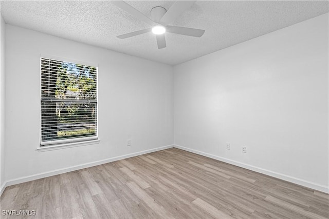 spare room with ceiling fan, a textured ceiling, and light hardwood / wood-style flooring