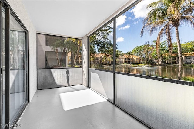 unfurnished sunroom with a water view and a healthy amount of sunlight