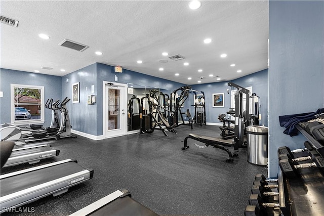 gym with a textured ceiling