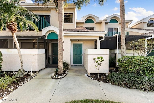 doorway to property featuring stucco siding