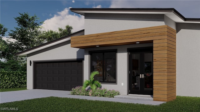 doorway to property with concrete driveway, an attached garage, and stucco siding