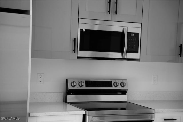 919 Columbus Blvd S, Lehigh Acres, FL 33974 - kitchen with appliances with stainless steel finishes and light countertops