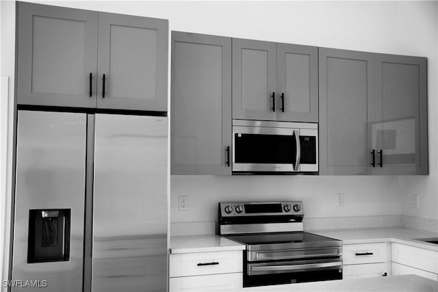 919 Columbus Blvd S, Lehigh Acres, FL 33974 - kitchen featuring appliances with stainless steel finishes, gray cabinetry, and light countertops