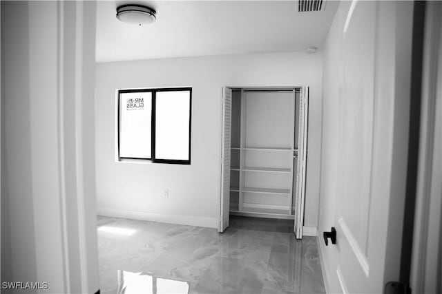 919 Columbus Blvd S, Lehigh Acres, FL 33974 - unfurnished bedroom with marble look tile flooring and baseboards