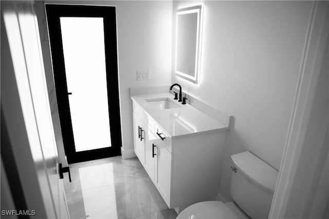 919 Columbus Blvd S, Lehigh Acres, FL 33974 - half bathroom featuring toilet, vanity, and marble look tiles