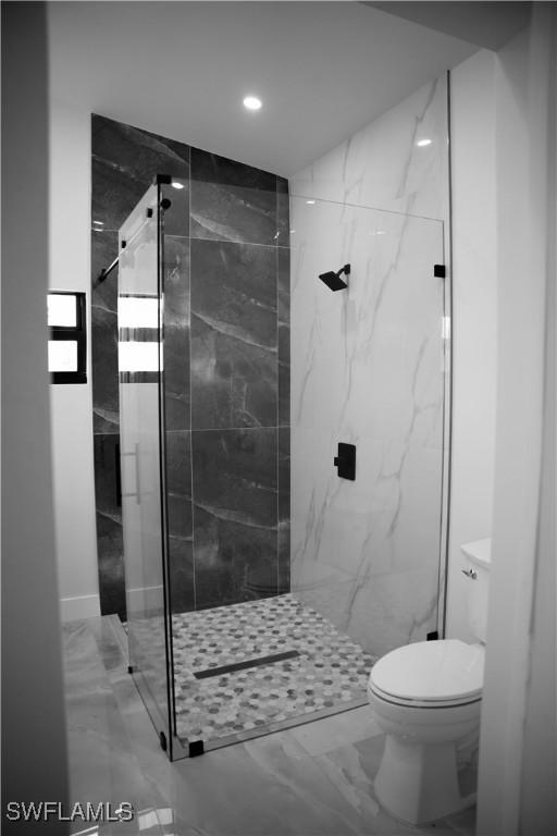 919 Columbus Blvd S, Lehigh Acres, FL 33974 - full bath with marble finish flooring, toilet, a marble finish shower, and recessed lighting