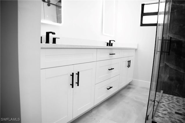 919 Columbus Blvd S, Lehigh Acres, FL 33974 - bathroom with marble look tile flooring, double vanity, a stall shower, and baseboards