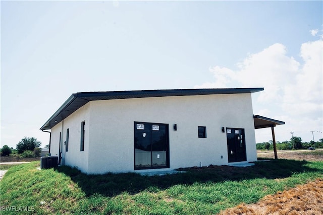 919 Columbus Blvd S, Lehigh Acres, FL 33974 - back of property with stucco siding and central AC