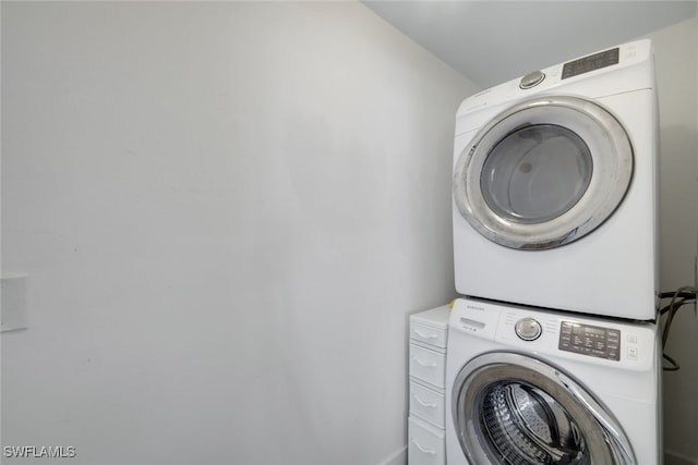 laundry area with stacked washer and dryer and laundry area