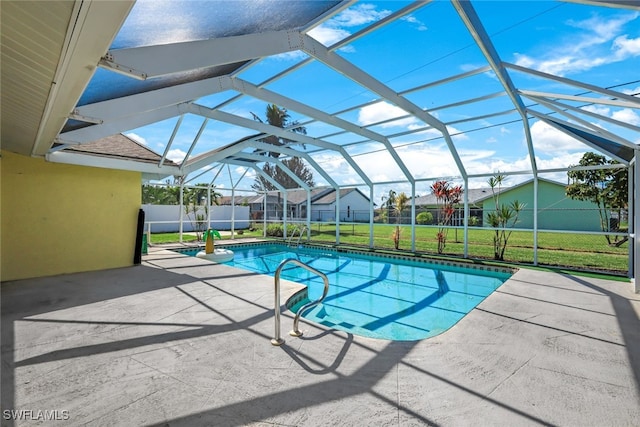 view of pool with glass enclosure, a patio, a lawn, and a fenced in pool