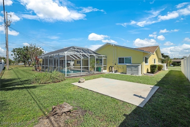 back of property with stucco siding, a patio area, fence, a lanai, and an outdoor pool