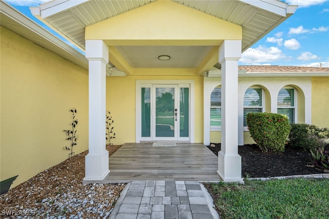 property entrance with stucco siding