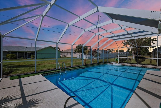 pool featuring a lawn, a patio area, and a lanai