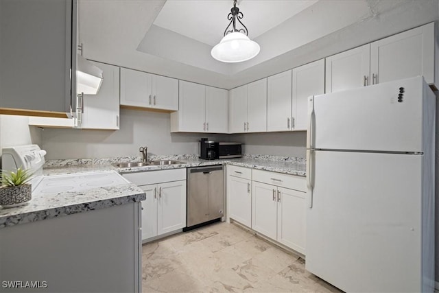 kitchen with sink, appliances with stainless steel finishes, hanging light fixtures, white cabinets, and a raised ceiling