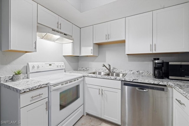 kitchen with stainless steel appliances, light stone countertops, sink, and white cabinets