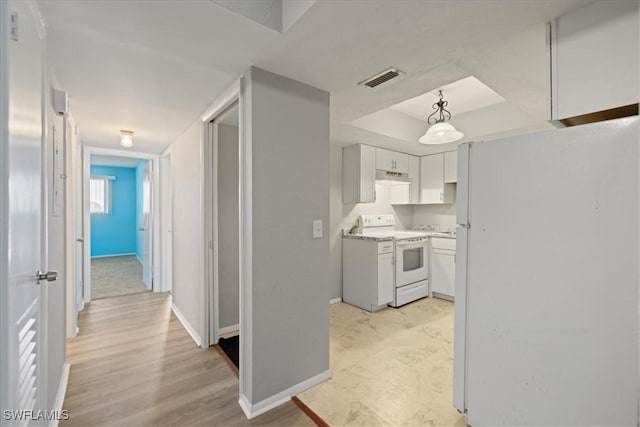 kitchen featuring white cabinetry, white appliances, light hardwood / wood-style flooring, and pendant lighting