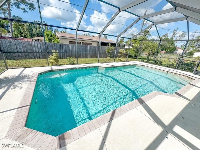 view of pool featuring glass enclosure and a patio area