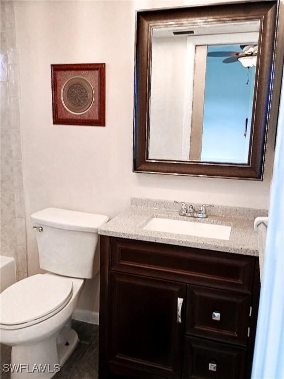 bathroom featuring vanity, ceiling fan, tile patterned flooring, and toilet